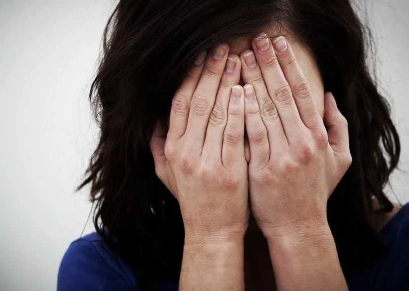 Person with head in hands, expressing heartbreak