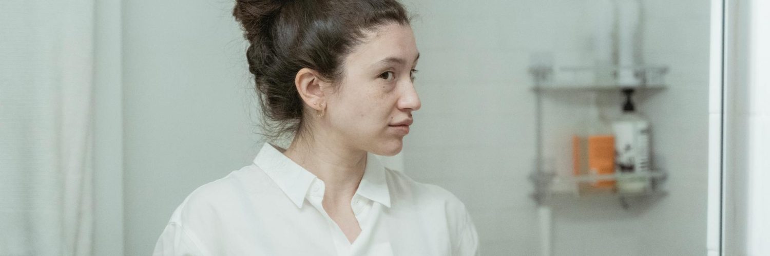 woman looking in mirror