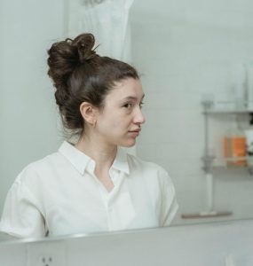 woman looking in mirror