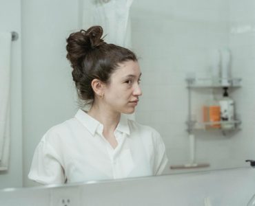 woman looking in mirror